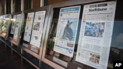 FILE - Newspaper front pages are displayed at the Newseum in Washington, July 10, 2017. U.S. lawmakers from both major political parties are supporting legislation that makes it easier for media companies to negotiate deals with internet companies. (AP Photo/Carolyn Kaster)