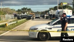 FILE - Police patrol the area outside Marjory Stoneman Douglas High School following a school shooting in Parkland, Florida, Feb. 15, 2018.