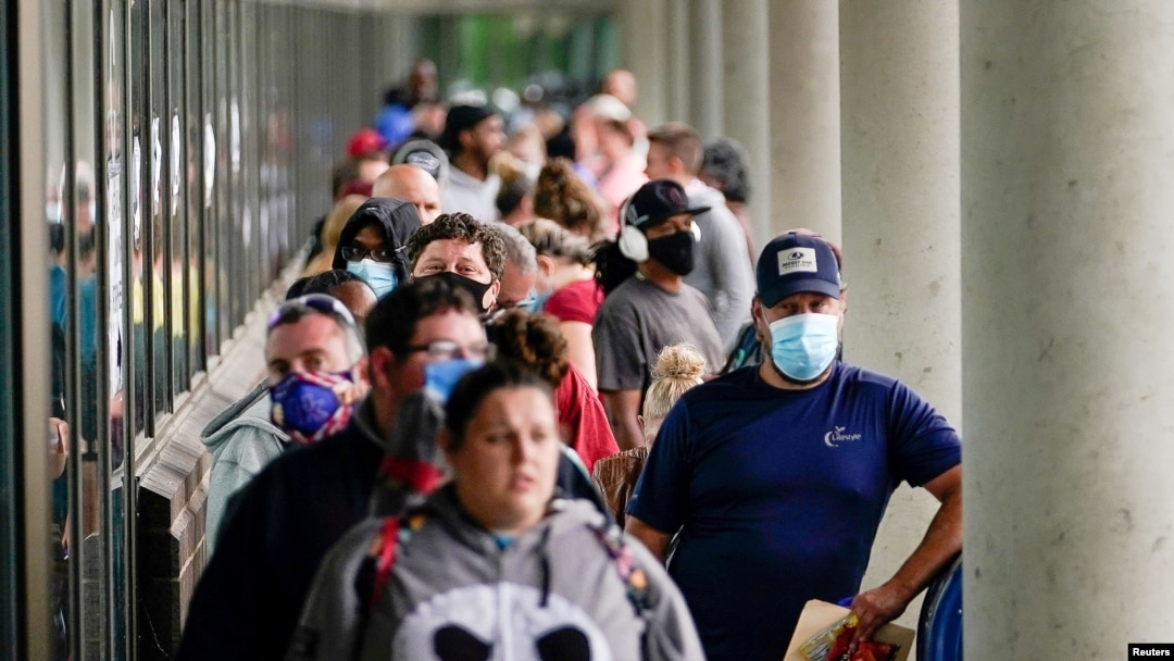 FILE - Job seekers line up outside a Career Center in Frankfort, Kentucky, June 18, 2020. 
