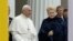 Pope Francis smiles as he arrives with Lithuanian President Dalia Grybauskaite, right, ahead of a meeting with officials, civil society and diplomatic corps in the square in front of the Presidential Palace, in Vilnius, Lithuania, Sept. 22, 2018.