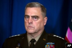 Chairman of the Joint Chiefs of Staff Gen. Mark Milley listens as Secretary of State Mike Pompeo delivers a statement on Iraq and Syria, Dec. 29, 2019, in Palm Beach, Fla.