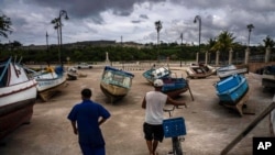 Fishermen inspect their boats after they have been taken out of the bay to avoid damage from the passage of Tropical Storm Elsa, in Havana, Cuba, July 5, 2021. 