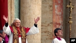 Pope Benedict the 16th waves to the crowd from the central balcony of St. Peter's Basilica after being newly elected, the Vatican, April 19, 2005.