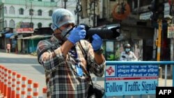 Agence France Presse photographer Diptendu Dutta works in India on April 10, 2020, during a government-imposed nationwide lockdown to prevent the spread of the COVID-19 coronavirus.