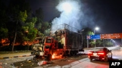 A rally truck used by Bushra Bibi, the wife of Pakistani former Prime Minister Imran Khan, burns near an area that was cordoned off by police after protests to demand Khan's release in Islamabad on Nov. 27, 2024.