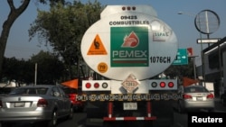 FILE - A tanker truck transporting fuel is pictured along the streets en route to a gas station, in Mexico City, Mexico, Jan. 15, 2019. 