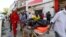 Somali emergency services evacuate a body from a car bombing at a shopping mall in Mogadishu, Somalia, Feb. 4, 2019. Al-Shabab claimed responsibility for the attack.