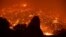 Firefighters battle the Powerhouse wildfire at the Angeles National Forest, with the fire now having destroyed several homes near the Lake Hughes area in California, early morning, June 2, 2013. 