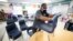 Des Moines Public Schools custodian Tracy Harris cleans chairs in a classroom at Brubaker Elementary School in Des Moines, Iowa, July 8, 2020.