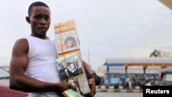 A boy sells a music CD along a road in NIgeria's oil hub city of Port-Harcourt July 8, 2010. 