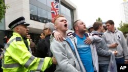 People heckle the Mayor of London, Boris Johnson, not pictured, as he leave the scene of a terror attack in Woolwich, southeast London, May 23, 2013.