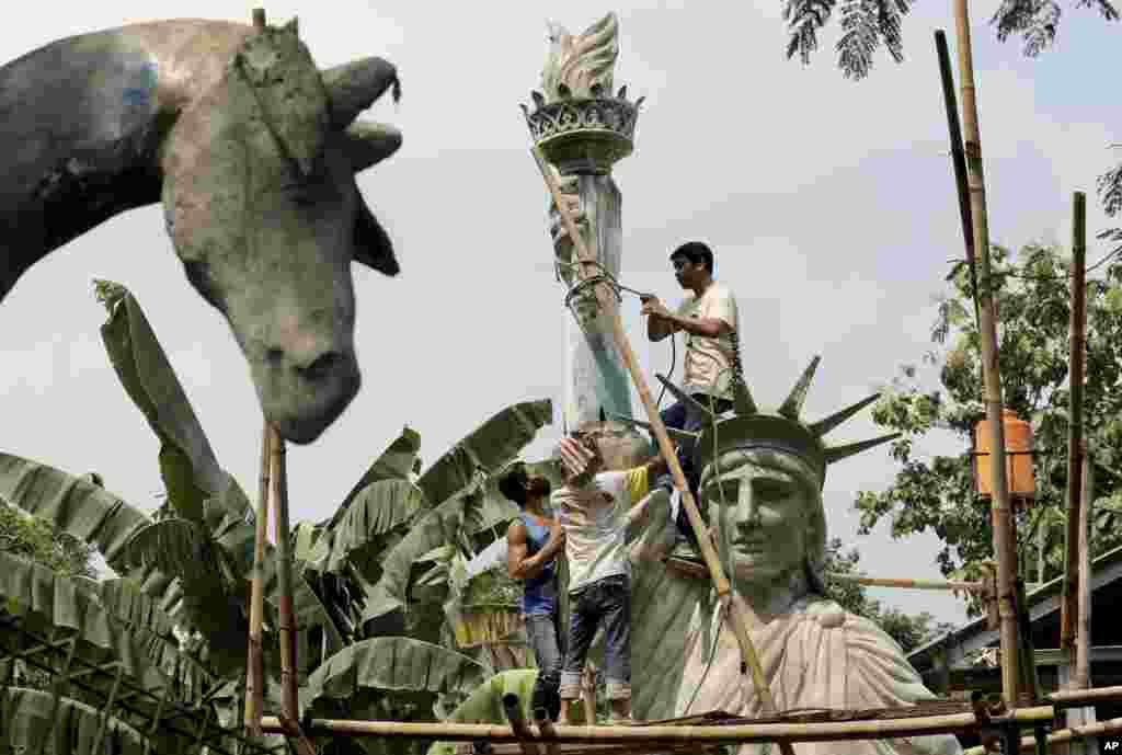 Workers build a large replica of the Statue of Liberty at a workshop in Jakarta, Indonesia.