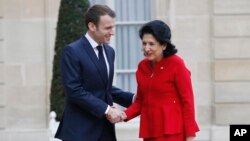 French President Emmanuel Macron, left, welcomes Georgia's President Salome Zurabishvili at the Elysee Palace in Paris, France, Feb. 19, 2019. 