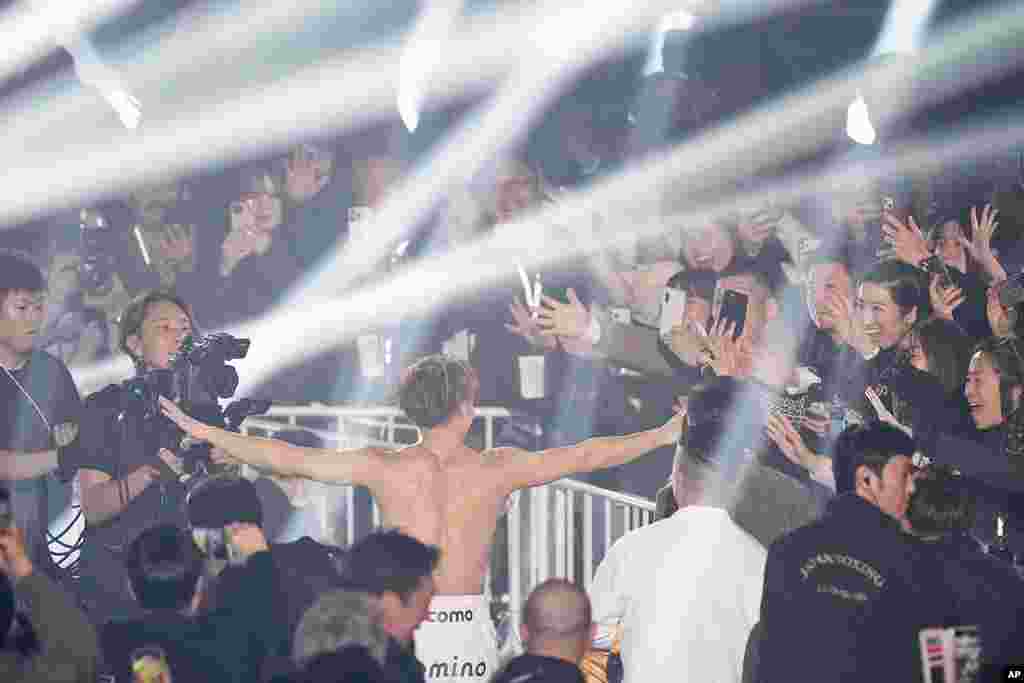 Fans cheer as Japanese champion Naoya Inoue leaves the ring after defending his unified WBC IBF and WBO super bantamweight world title at the Ariake Arena in Tokyo.