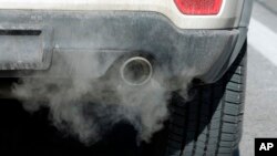 FILE - Exhaust comes from the tailpipe of a vehicle, in Salt Lake City, Utah, Jan. 3, 2019.