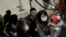 Travelers wearing masks arrive on a direct flight from China on Jan. 23, 2020, at Seattle-Tacoma International Airport.