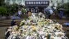 Flowers are laid at a makeshift memorial to mourn Yuan Longping, a Chinese agronomist known for developing the first hybrid rice varieties in the 1970s, at Hunan Hybrid Rice Research Center. This photo was taken on May 23, 2021, in Changsha.