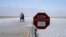 A sign warns of extreme heat danger at Badwater Basin, Aug. 17, 2020, in Death Valley National Park, California. 