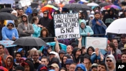 A person hold up a sign that reads "Fund Climate Change Research Saving The Planet Is Not a Waste of Money" during the March for Science in Washington, D.C., April 22, 2017.