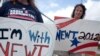 Two unidentified supporters of Republican presidential candidate Newt Gingrich stand outside a Hallande, Florida polling center on January 31, 2012 (AP)