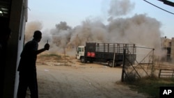 Palestinians take cover during an Israeli air strike on a house in Rafah, in the southern Gaza Strip, July 23, 2014. 