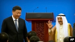 FILE— Kuwait's ruling emir, Sheikh Sabah Al Ahmad Al Sabah, right, waves as he stands with Chinese President Xi Jinping after speaking during the opening session of the 8th Ministerial Meeting of the China-Arab States Cooperation Forum in Beijing, July 10, 2018.