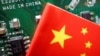 FILE PHOTO: A Chinese flag is displayed next to a "Made in China" sign seen on a printed circuit board with semiconductor chips, in this illustration picture taken February 17, 2023. (REUTERS/Florence Lo/Illustration/File Photo)