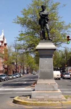 FILE - This April 23, 2003 file photo shows a statue of a Confederate soldier at an intersection in Alexandria, Va.