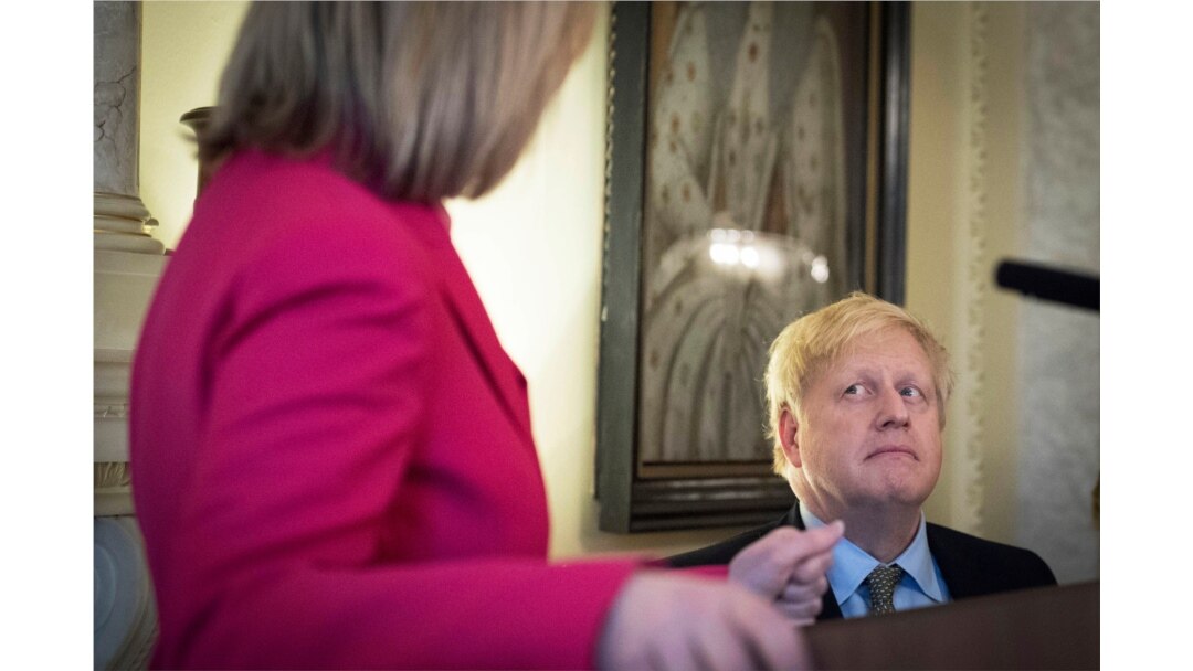 Britain's Prime Minister Boris Johnson listens to British politician Liz Truss during a panel event and reception to mark International Women's Day at Downing Street in Westminster, London, March 5, 2020.