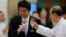 Japan's Prime Minister Shinzo Abe (L) and Burma's President Thein Sein toast during lunch at the Myanmar International Convention Center in Naypyitaw, May 26, 2013.
