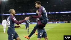 L’attaquant brésilien du Paris Saint-Germain, Neymar (à droite), son coéquipier français Layvin Kurzawa (centre en bas) du Paris Saint-Germain et Kylian Mbappe jubilent après un but lors du match du championnat français contre et Marseille (OM) au Parc de