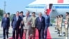 This handout photograph taken and released by Pakistan's Prime Minister Office on October 14, 2024 shows China's Premier Li Qiang (C, left) speaking with Pakistan's Prime Minister Shehbaz Sharif (C) upon his arrival at the Chaklala military air base in Is