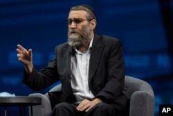 FILE - Israeli politician Moshe Gafni gestures as he speaks during a conference in Jerusalem, Sunday, March 7, 2021.