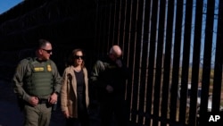 US Vice President Kamala Harris talks with John Modlin, chief patrol agent for the Tucson Sector of the US Border Patrol, right, and Blaine Bennett, US Border Patrol Douglas Station border patrol agent in charge, at the US border with Mexico in Douglas, Ariz., Sept. 27, 2024. 