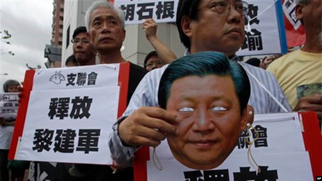 Protester holds mask of Chinese President Xi Jinping during demonstration for Chinese journalist Gao Yu, Hong Kong publisher Yao Wentian, and Chinese lawyer Pu Zhiqiang, Chinese liaison office, Hong Kong, May 11, 2014.