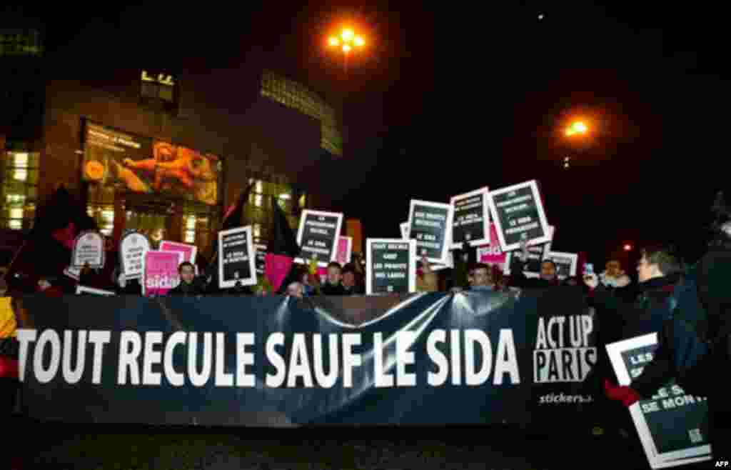 People demonstrate to mark the World AIDS Day, at Bastille place in Paris, Wednesday Dec. 1, 2010. An United Nations report has revealed that nearly 33.4 million people are infected by the HIV virus throughout the world. The banner reads Everything moves