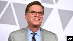 FILE - Aaron Sorkin arrives at the 90th Academy Awards Nominees Luncheon in Beverly Hills, Calif., Feb. 5, 2018. The estate of "To Kill a Mockingbird" author Harper Lee has filed suit over an upcoming Broadway adaptation of the novel set to open in December.