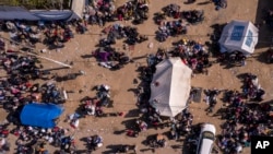 A photo taken by a drone shows displaced Palestinians gathered with their belongings as they wait to return to their homes in the northern part of the Gaza Strip, Jan. 26, 2025, days after a ceasefire deal between Israel and Hamas came into effect.