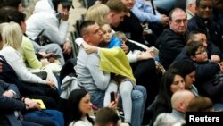 A child draped in a Ukrainian flag attends the weekly general audience at the Vatican, Feb. 22, 2023.