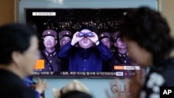 FILE - A TV news program shows a file image of North Korean leader Kim Jong Un at the Seoul Railway Station in Seoul, South Korea, May 14, 2017. 