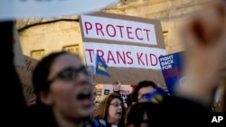 FILE - Activists and protesters with the National Center for Transgender Equality rally in front of the White House, Feb. 22, 2017.