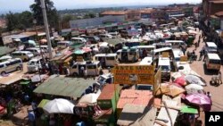 FILE - Passenger service vehicles, that will benefit from the new tarmac road, work in Ndunyu Njeru, Kenya, January 24, 2024.