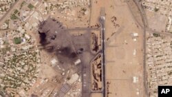 This satellite photo from Planet Labs PBC shows damaged aircraft, including one on fire, at Khartoum International Airport in Khartoum, Sudan, Monday, April 17, 2023. 