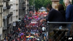 People march during a May Day rally in the center of Barcelona, Spain, Tuesday, May 1, 2018. May 1 is celebrated as the International Labor Day, or May Day, across the world.