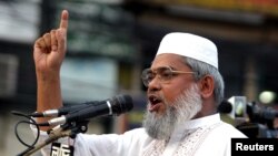FILE - Bangladesh Minister for Social Welfare Ali Ahsan Mojaheed addresses a protest rally organized by the Jamat -e-Islami Party in Dhaka, April 21, 2006.