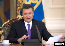 FILE - Ukraine's President Viktor Yanukovych takes part in a news conference in Kyiv, Dec. 19, 2013.