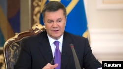 FILE -Ukraine's President Viktor Yanukovych takes part in a news conference in Kyiv, December 19, 2013.