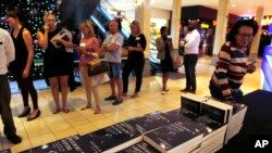 People queue to buy the newly published book by investigative journalist Jacques Pauw, at the launch of The President's Keepers, in Johannesburg, Nov. 8, 2017. 