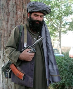 FILE - An Afghan-ruling Taliban fighter patrols in Kabul, Oct 2, 2001.