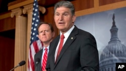Sen. Joe Manchin, D-W.Va., right, accompanied by Sen. Patrick Toomey, R-Pa., announce that they have reached a bipartisan deal on expanding background checks to more gun buyers, Wednesday, April 10, 2013, on Capitol Hill in Washington.